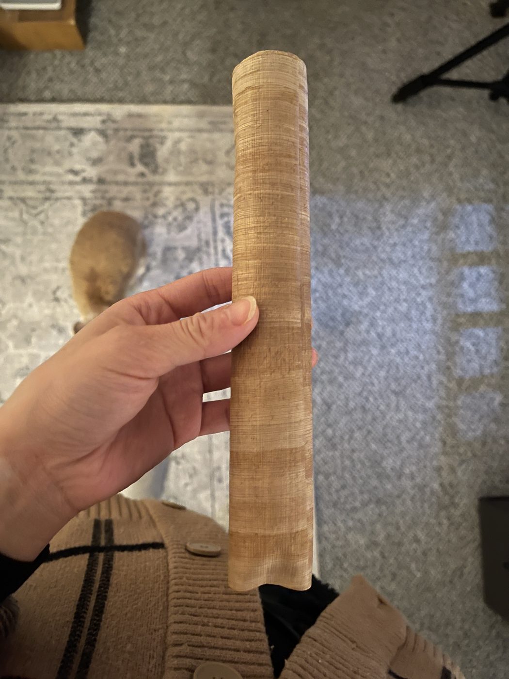 The baked scroll, toasted brown, held in a hand