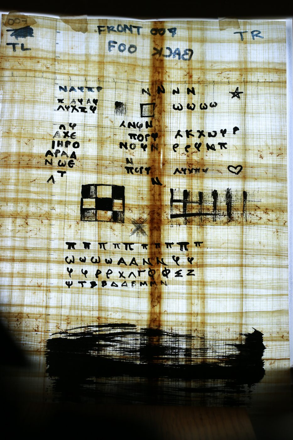 DSLR photo of the backlit test sheet with Greek letters and a checkerboard